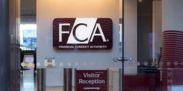 Entrance to the Financial Conduct Authority (FCA) office, showing a large FCA logo on the wall and a sign pointing to Visitor Reception, viewed through glass doors.