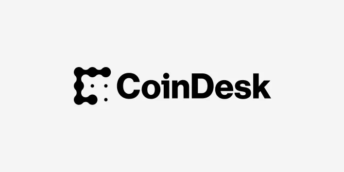 The CoinDesk logo features a black geometric design resembling a letter C made of dots, followed by the bold black text CoinDesk on a light gray background—an emblem familiar to anyone following senate crypto bill coverage.