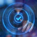Digital image with tick in the middle accompanying article about blockchain validation.