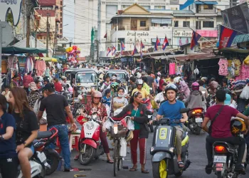 Busy street scene in Phnom Penh used to illustrate article about crypto's development in Cambodia.