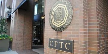 The exterior of a brick building displays the Commodity Futures Trading Commission (CFTC) seal and a sign with the acronym CFTC near the entrance.