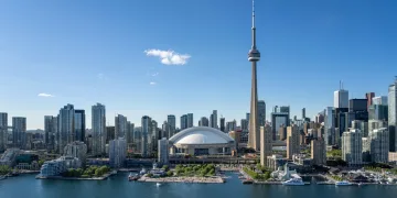 Image of Toronto's skyline by day featuring the CN Tower, used to accompany an article about crypto usage in Canada.