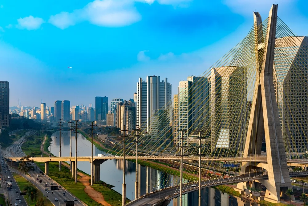Skyline of Sao Paulo at sunset with the city's most famous bridge in the foreground, used to illustrate an article about crypto usage in Brazil.