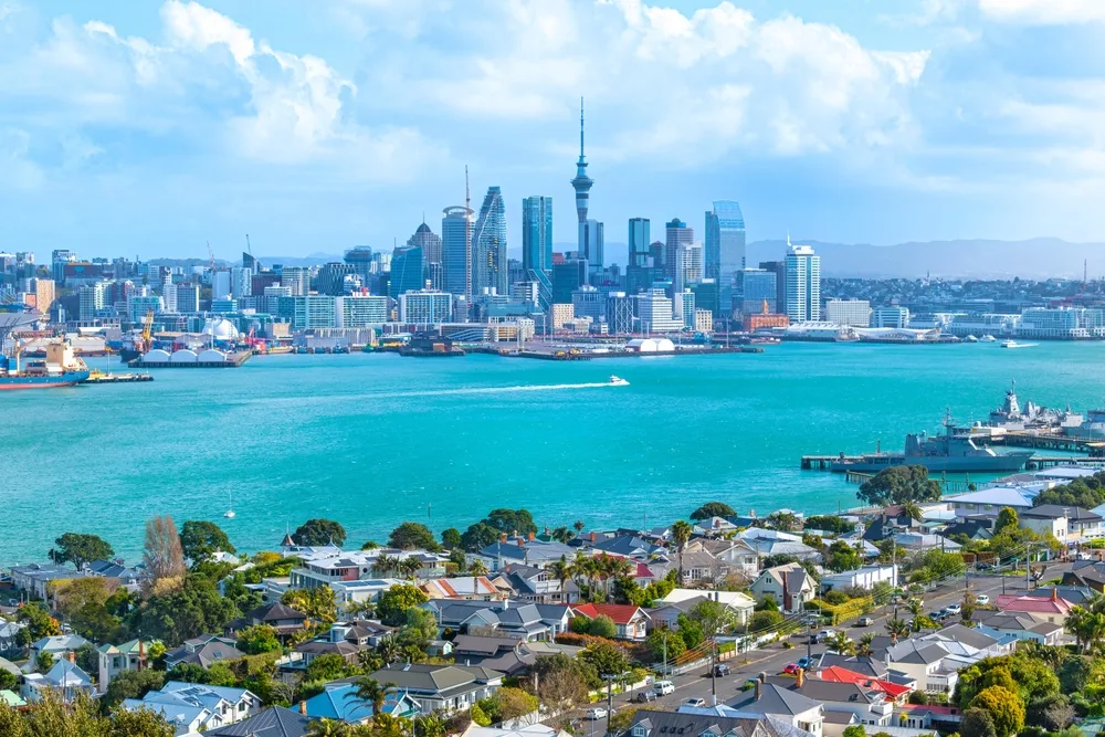 Scenic image of Auckland showing the CBD in the background and water in front, used to illustrate an article about crypto usage in New Zealand.