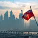 Maritime flag of Bermuda flutters in front of outline of city skyline in article about the take-up of crypto in Bermuda.