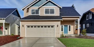 Image of a two storey well-kept American-styled wooden boarded house used to illustrate an article about crypto mortgages.