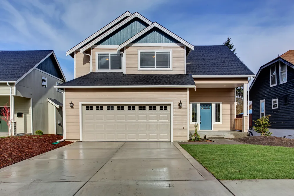 Image of a two storey well-kept American-styled wooden boarded house used to illustrate an article about crypto mortgages.